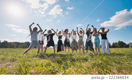 High school students happily leaping in a field, enjoying the start of summer break 122366034