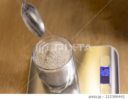 Coarse rye flour measured on the small electronic scale 122366442