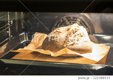 Shot of the freshly baked loaf of home made rye bread in the oven Shot of the freshly baked loaf of home made rye bread in the oven 122366515