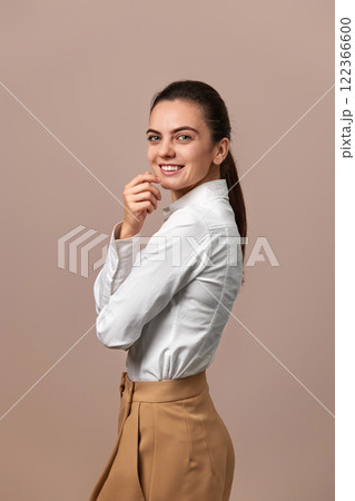 caucasian businesswoman lady with crossed arms in white shirt and beige pants 122366600