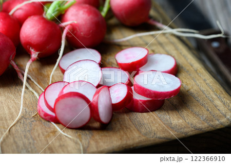 Fresh farm organic radish slices on wooden cutting board 122366910