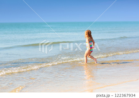 Kids playing on beach. Children play at sea. 122367934