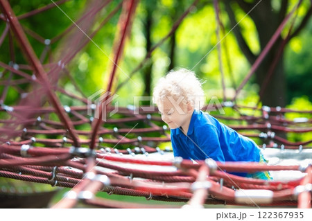 Child having fun on school yard playground Child having fun on school yard playground 122367935