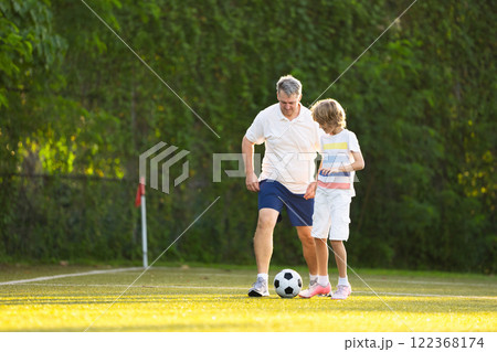 Child playing football. Kids play soccer. Child playing football. Kids play soccer. 122368174