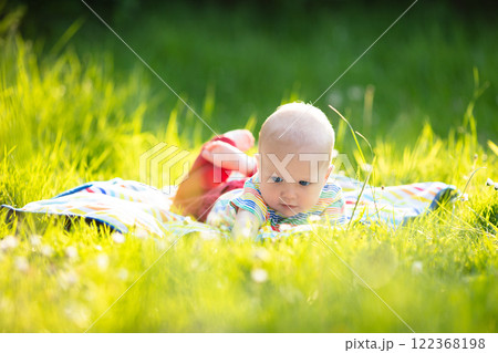Baby boy with apple on family garden picnic 122368198