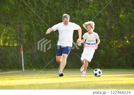Child playing football. Kids play soccer. Child playing football. Kids play soccer. 122368224