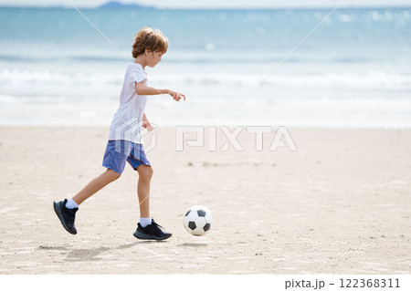 Child playing football. Kids play soccer. 122368311