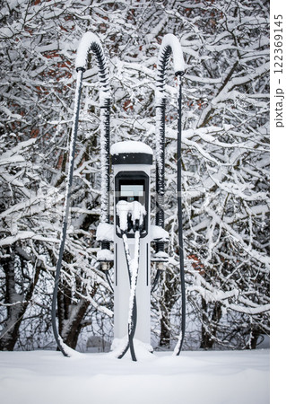Electric car charging station. Snowfall and large snowdrifts Electric car charging station. Snowfall and large snowdrifts 122369145