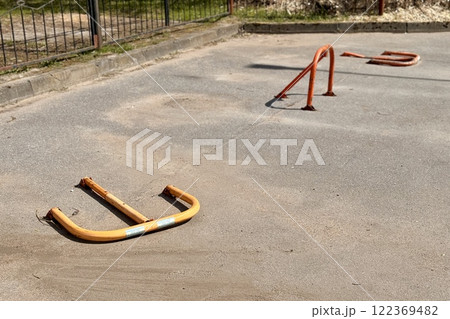 Metal parking space stoppers of car with key outdoor in special area in summer day Metal parking space stoppers of car with key outdoor in special area in summer day 122369482