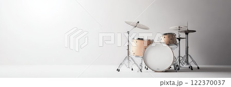 Professional drum set positioned in an empty white room, illuminated by soft light, inviting a musician to unleash creativity and craft captivating rhythms and sounds 122370037