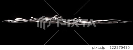 Metallic liquid surface creating ripples and drops with reflections on a black background, ideal for concepts related to water, liquids, and abstract designs 122370450