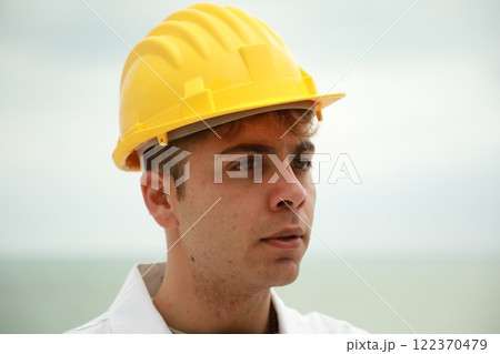 Engineer Angry About Bad Work Done By Workers Nervously Scolding Them On Beach 122370479