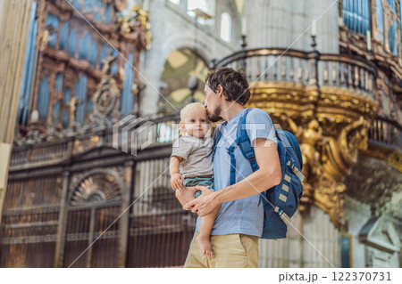 Father and his son tourists exploring the Metropolitan Cathedral in Mexico City. Woman admiring the architecture and history of Mexico's iconic landmark. Concept of cultural heritage, religious Father and his son tourists exploring the Metropolitan Cathedral in Mexico City. Woman admiring the architecture and history of Mexico's iconic landmark. Concept of cultural heritage, religious 122370731