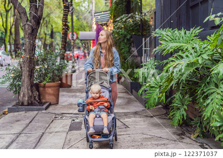 Mother with her son exploring lush streets of Condesa, Mexico City. Family adventure in a vibrant urban oasis. Travel, family bonding, and urban greenery concept in Latin America 122371037