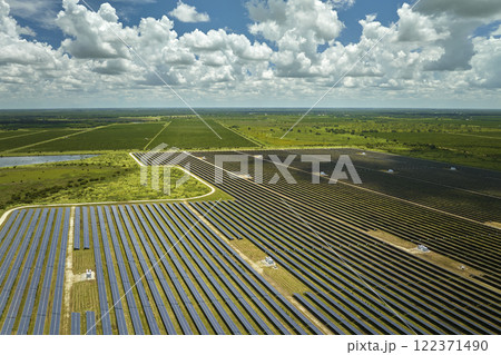Aerial view of big sustainable electric power plant with many rows of solar photovoltaic panels for producing clean electrical energy. Renewable electricity with zero emission concept 122371490
