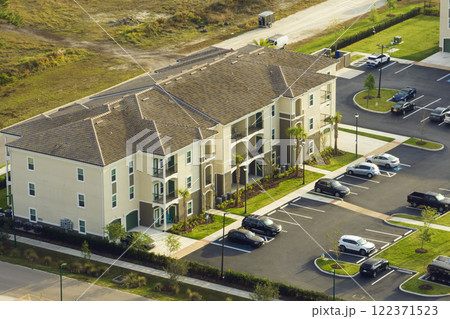 Aerial view of american apartment buildings in Florida residential area. New family condos as example of housing development in US suburbs Aerial view of american apartment buildings in Florida residential area. New family condos as example of housing development in US suburbs 122371523
