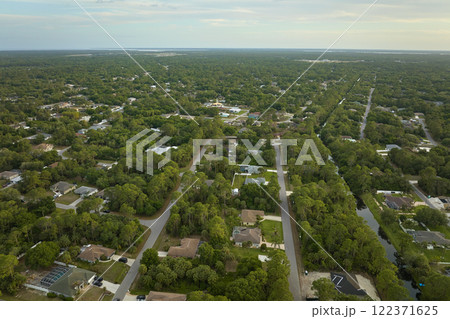 Aerial landscape view of suburban private houses between green palm trees in Florida rural area Aerial landscape view of suburban private houses between green palm trees in Florida rural area 122371625