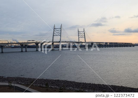 The remarkable Suspension Bridge stands majestically at dusk over the calm, serene waters The remarkable Suspension Bridge stands majestically at dusk over the calm, serene waters 122373472