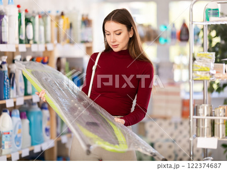 Woman choosing a folding board Woman choosing a folding board 122374687