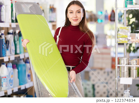 Woman choosing a folding board Woman choosing a folding board 122374834