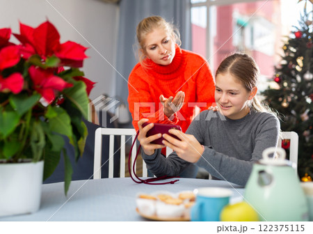Mother is unhappy with daughter while daughter plays on smartphone 122375115
