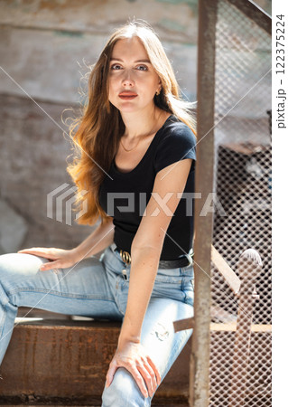 Portrait of attractive woman in abandoned building 122375224