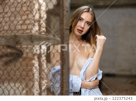 Sensual woman undressing in deserted building 122375243