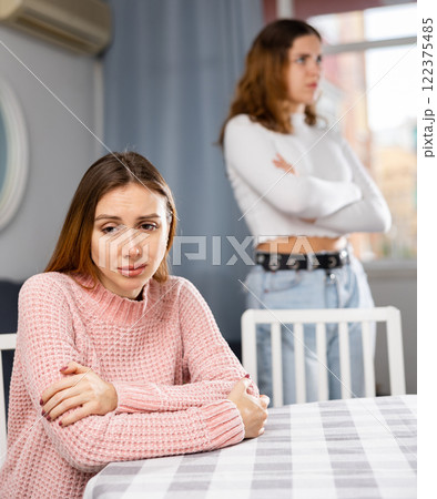 Two sisters do not want to communicate after domestic quarrel at home Two sisters do not want to communicate after domestic quarrel at home 122375485