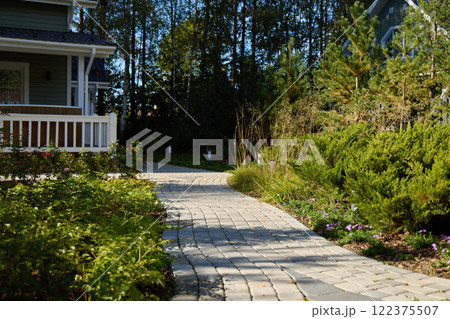 A Charming Pathway Nestled Within a Lush and Beautiful Residential Garden Setting 122375507