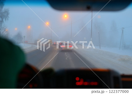 A Foggy Winter Drive Engaging Evening Commute in Challenging Snowy Conditions Ahead 122377000
