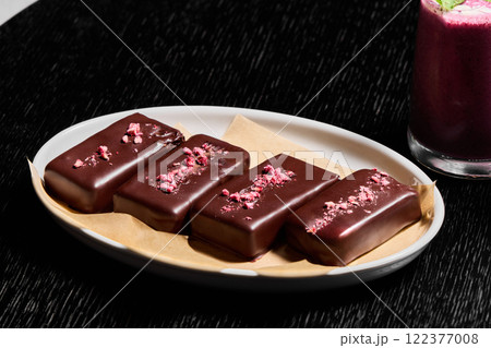 Indulgent and Delicious Chocolate Bars with Various Toppings Displayed on a Plate Indulgent and Delicious Chocolate Bars with Various Toppings Displayed on a Plate 122377008