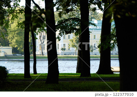 Enjoying a Serene View of the River as It Flows Gently Through Trees in a City Park Enjoying a Serene View of the River as It Flows Gently Through Trees in a City Park 122377010
