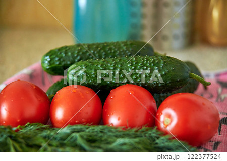 Tomatoes, cucumbers and green dill close-up, fresh harvest, preparation for salad, diet food 122377524