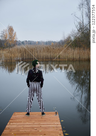 A Contemplative Figure by the Water while Wearing Striped Trousers in Autumnal Scenery A Contemplative Figure by the Water while Wearing Striped Trousers in Autumnal Scenery 122377554