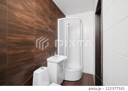 Explore modern bathroom design featuring a stylish shower and a sleek toilet space 122377581