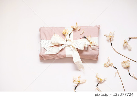 Sustainable cloth wrapped gift decorated dried flowers. Sustainable cloth wrapped gift decorated dried flowers. 122377724