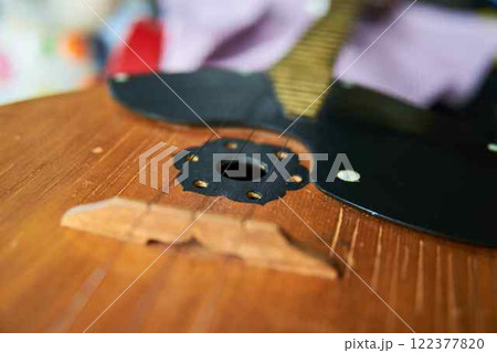 Close-up image of a domra with three golden strings. Selective focus. 122377820
