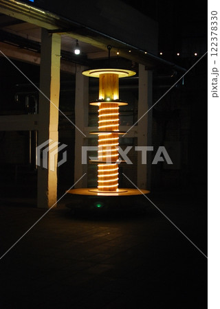 An Illuminated High Voltage Coil art piece shown in a dark setting with unique effects 122378330