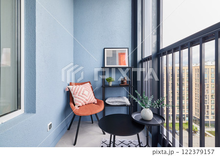 A Stylish and Modern Balcony Featuring Cozy Seating Arrangements and Chic Decorative Elements A Stylish and Modern Balcony Featuring Cozy Seating Arrangements and Chic Decorative Elements 122379157