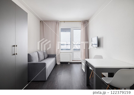 A Modern Minimalist Living Space with Natural Light, Functional Design, and elegance 122379159