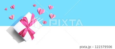 Gift box with pink paper hearts 122379506