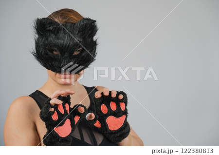 Portrait of a woman in a cat costume on a white background. Quadrober.  122380813