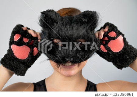 Portrait of a woman in a cat costume on a white background. Quadrober.  122380961