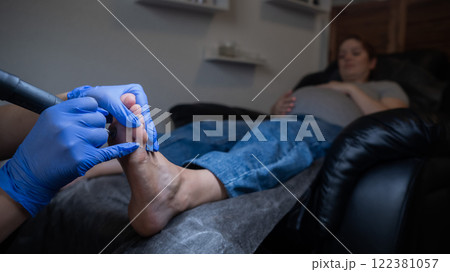 Pregnant woman on a hardware pedicure procedure in a beauty salon.  122381057