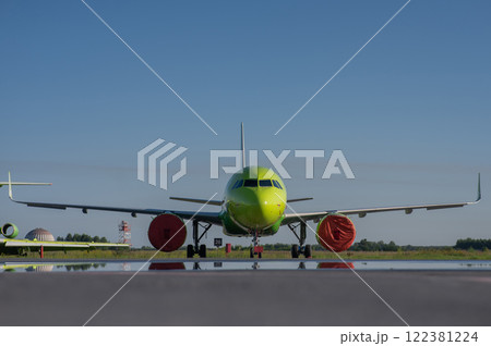 Airplane undergoing repairs in the open air. Airplane undergoing repairs in the open air. 122381224