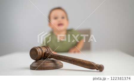 Little boy behind judge's gavel.  122381374