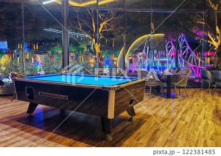 pool table inside restaurant with outdoor light up view at night pool table inside restaurant with outdoor light up view at night 122381485