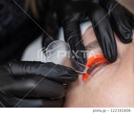 Caucasian woman undergoing eyelash lamination procedure. Caucasian woman undergoing eyelash lamination procedure. 122381606