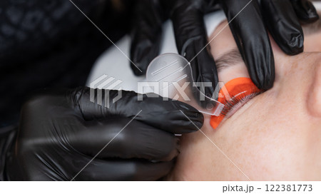 Caucasian woman undergoing eyelash lamination procedure. Caucasian woman undergoing eyelash lamination procedure. 122381773