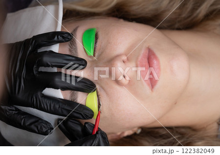 Caucasian woman undergoing eyelash lamination procedure.  122382049